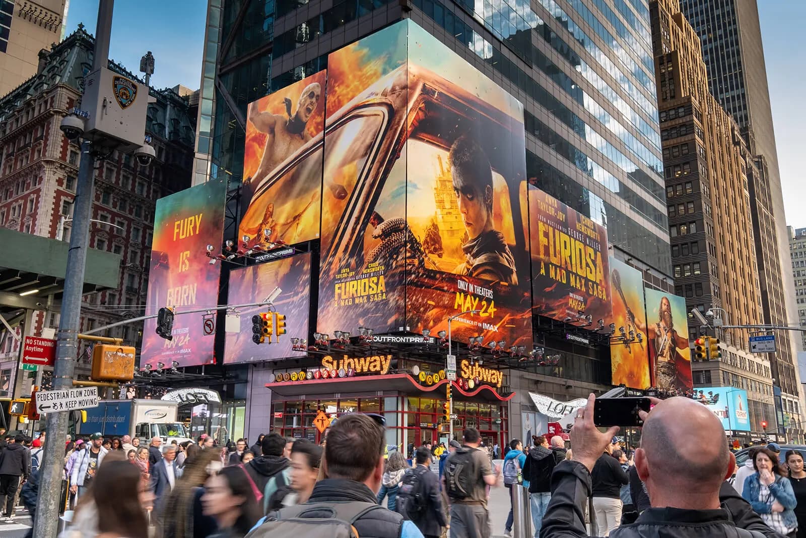 OUTFRONT Media billboards above a crowded Times Square intersection